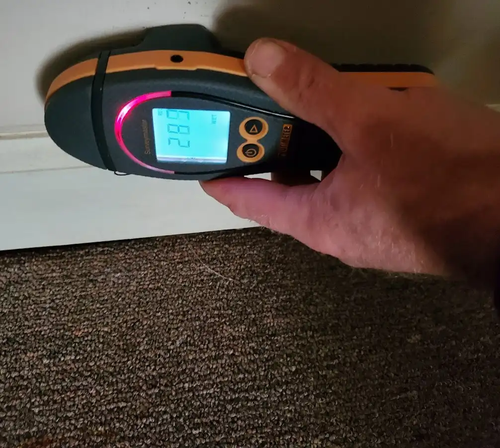 Moisture detection at baseboard during Storm Damage Restoration in Highland Village
